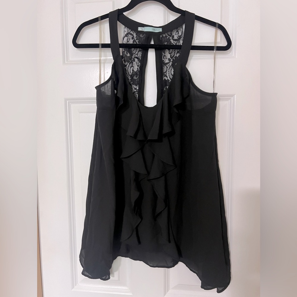 Maurices black tank top with front ruffles, shark bite hem, and lace back detail
